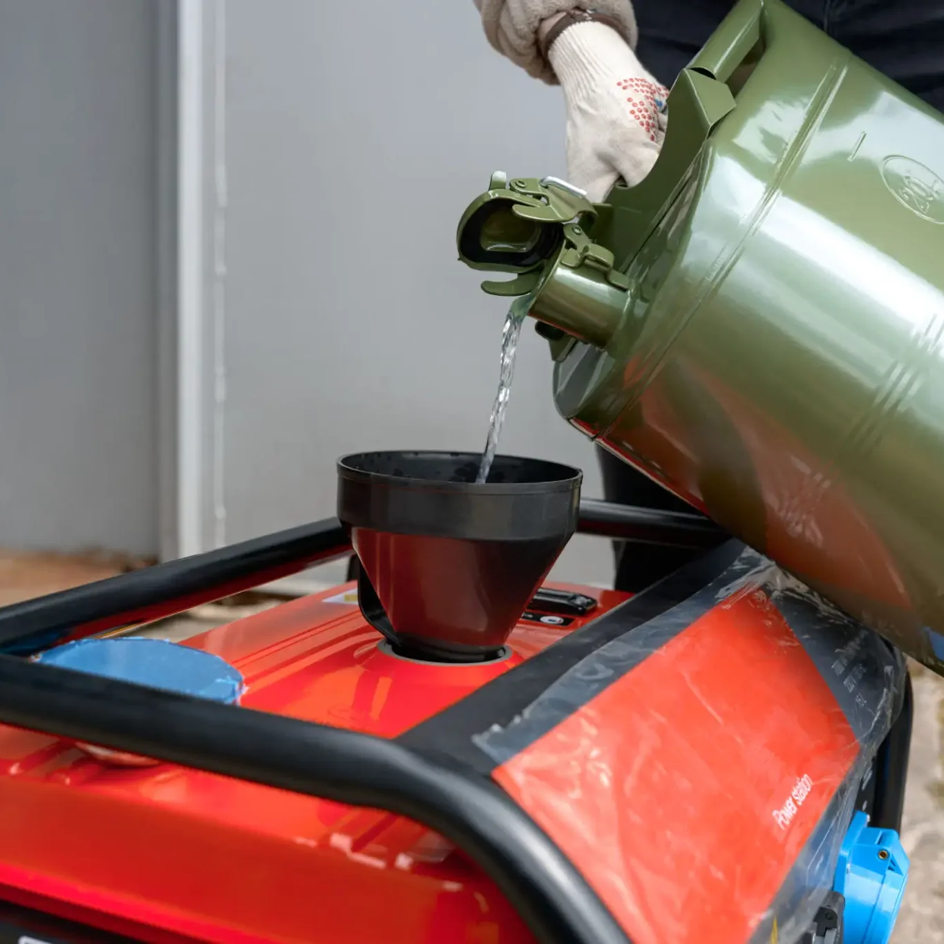Pouring fuel from jerrycan into portable generator
